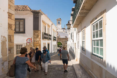 Faro,Portugal-august 13, 2017:people walking through the narrow streets narrow streets of Faro during a sunny dayのeditorial素材