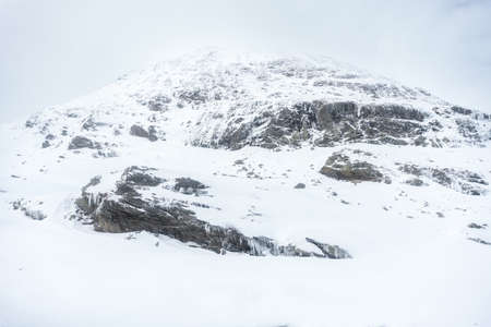 landscape from the trainstation of Alp Grum along the way of the red train of the bernina during a cloudy day.の写真素材