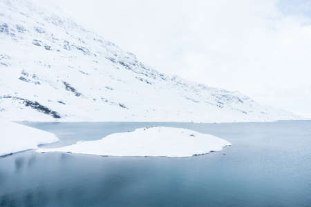 landscape from the trainstation of hospice Bernina along the way of the red train of the bernina during a cloudy day.の写真素材