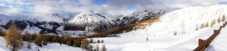 Snow-covered landscape in the autumn along the way near Livigno in a sunny dayの写真素材