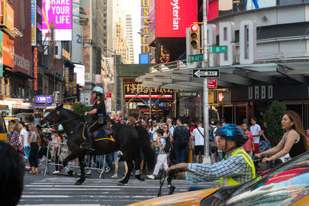 New York City, USA - August 7, 2019: Policeman on horseback among New York city traffic during a sunny dayのeditorial素材