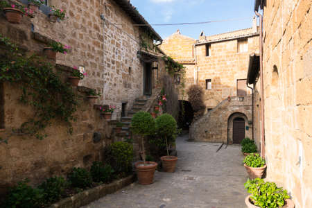 Civita di Bagnoregio, Italy-april 30,2018: strolling in the narrow street of Civita di Bagnoregio during a sunny day.Defined "the dying city" because it was built on a tuff spur destined to collapseのeditorial素材