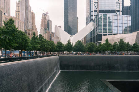 New York City, USA - August 7, 2019: people stroll during a cloudy day in New York near the subway station called Oculus designed by Santiago Calatrava and the monument of Ground zeroのeditorial素材