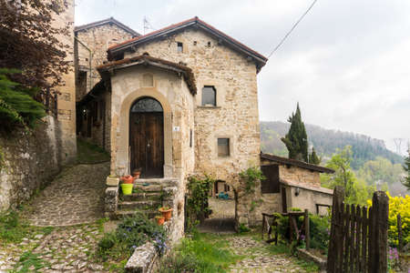 Borgo la Scola, Italy-April 2, 2017: Strolling through Borgo La Scola, one of the best preserved medieval villages of the Bolognese Apennines during a cloudy dayのeditorial素材