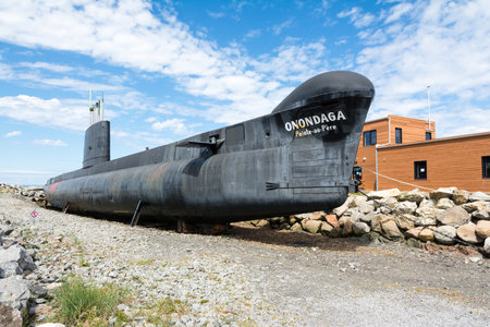 Rimouski, Canada - August 9, 2015: View of the Pointe au Pere lighthouse in the Gaspesie peninsula during a sunny day. This location also has the HMCS Onondaga museum (S73), a submarine where you can visit the interiorのeditorial素材