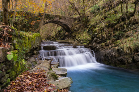 View of the bridge near the mill of the squaglia during an autumn dayの写真素材