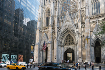 New York City, USA - August 8, 2019:people strolling on Fifth Avenue in front of St. Patrick's...