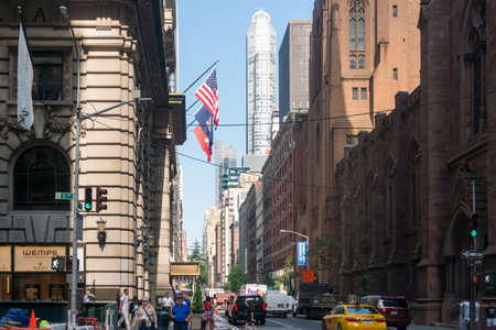New York City, USA - August 8, 2019:people strolling among the skyscrapers in Manhattan during a...