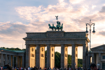 Berlin, Germany-august 8, 2022:People and tourists stroll in Pariser platz in front of Brandeburg gate during a sunsetのeditorial素材