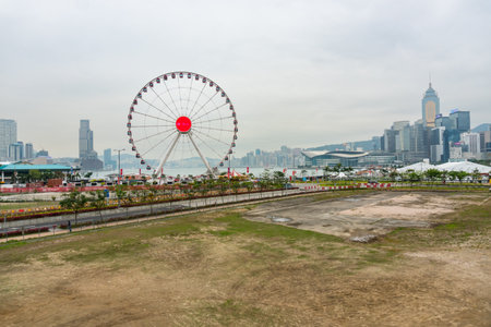 Hong Kong,March 25,2019:The Ferris wheel gi Hong Kong against the backdrop of the city's skyscrapers on a cloudy dayのeditorial素材