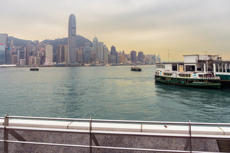 Hong Kong,March 25,2019:View of the Hong Kong skyscrapers from the Avenue of star on the Victoria Harbor during a cloudy dayのeditorial素材