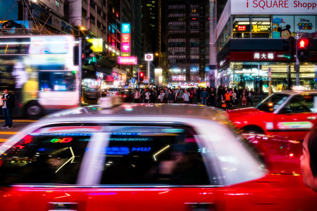 Hong Kong,March 25,2019:people among the skyscrapers through the streets of Hong Kong during a nightのeditorial素材