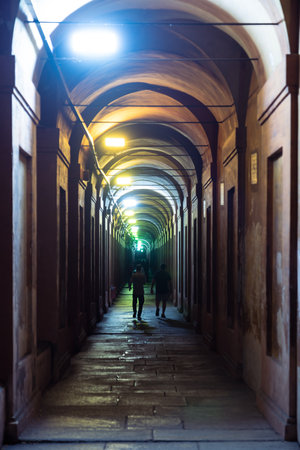 Bologna,Italy- June 23, 2023:People stroll at night under the arcades leading to the sanctuary of San Luca illuminated for the first edition of the Bologna arcades Festival. This is the longest arcades in the world and is now part of the Unesco heritageのeditorial素材