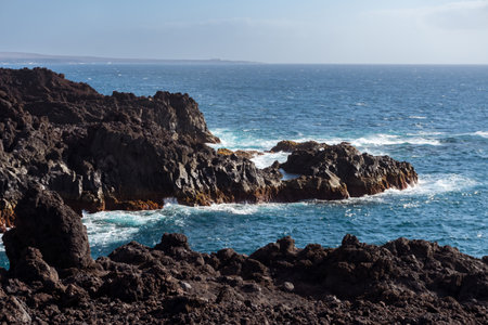 View of a stretch of coast of Lanzarote called Los Hervideros during a sunny dayの写真素材