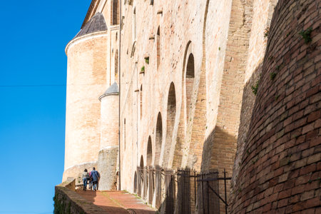 Urbino, Italy-april 27, 2019:walking through the ancient streets near the Ducal Palace of Urbino during a sunny dayのeditorial素材