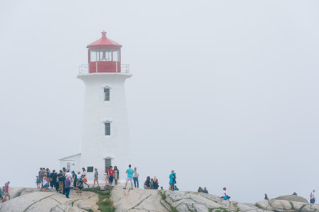 Peggy's Cove, Canada - August 13, 2015:people near the Peggy's Cove lighthouse in Nova Scotia-Canada during a foggy dayのeditorial素材