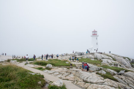 Peggy's Cove, Canada - August 13, 2015:people near the Peggy's Cove lighthouse in Nova Scotia-Canada during a foggy dayのeditorial素材
