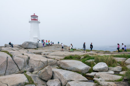 Peggy's Cove, Canada - August 13, 2015:people near the Peggy's Cove lighthouse in Nova Scotia-Canada during a foggy dayのeditorial素材