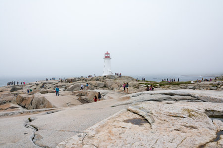Peggy's Cove, Canada - August 13, 2015:people near the Peggy's Cove lighthouse in Nova Scotia-Canada during a foggy dayのeditorial素材