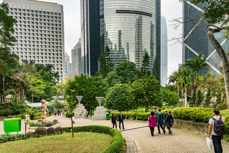 Hong Kong,March 26,2019:people inside the Hong Kong park, a city park surrounded by skyscrapers during a sunny dayのeditorial素材