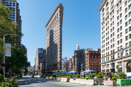 New York City, USA - August 9, 2019:people strolling among the famous skyscraper called Fatiron...