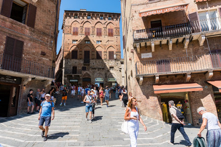 Siena,Italy-August 10, 2020:People and tourists visit the famous Piazza del Campo during a sunny dayのeditorial素材
