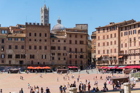 Siena,Italy-August 10, 2020:People and tourists visit the famous Piazza del Campo during a sunny dayのeditorial素材
