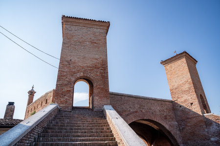 Comacchio ,Italy-June 2, 2023:people stroll in Comacchio in front off the famous three bridges...