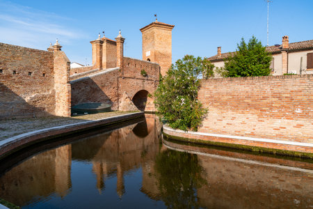 Comacchio ,Italy-June 2, 2023:strolling in Comacchio in front off the famous three bridges during a sunny dayのeditorial素材