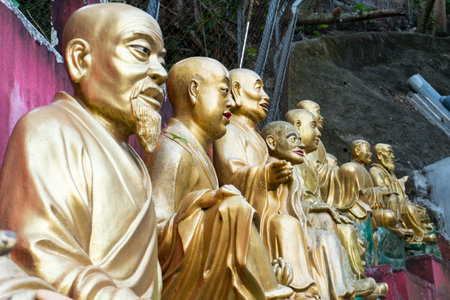 Hong Kong,March 27, 2019:The long and steep staircase with Buddha statues leading to the famous Ten Thousand Buddhas Monastery during a cloudy dayのeditorial素材