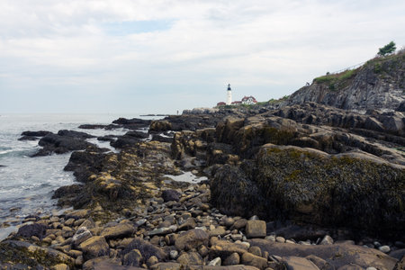 Portland, USA - August 13, 2019:view of the Portland Head Light a historic lighthouse in Cape Elizabeth, Maine during a cloudy dayの写真素材