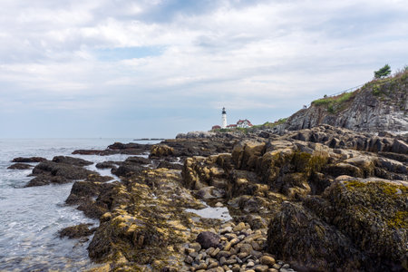 Portland, USA - August 13, 2019:view of the Portland Head Light a historic lighthouse in Cape Elizabeth, Maine during a cloudy dayの写真素材
