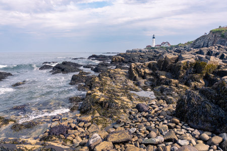 Portland, USA - August 13, 2019:view of the Portland Head Light a historic lighthouse in Cape Elizabeth, Maine during a cloudy dayの写真素材
