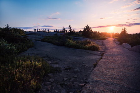 people on the highest point of Acadia National Park in Maine during a sunsetの写真素材