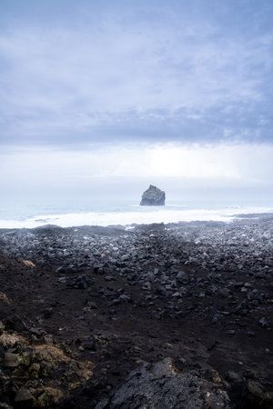 Vertical photograph of rock formations on the stretch of coast called Valahnukamol on the Reykjanes Peninsula during a cloudy dayの写真素材