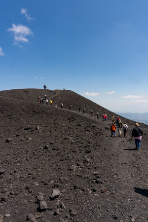 Etna, Italy-May 13, 2022:vertical photograph of people on the paths near the craters of the Etna volcano during a sunny dayのeditorial素材