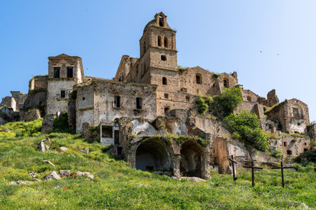 Craco, Italy-April 25, 2025:Ruins of the Mother Church of San Nicola in Craco in the middle of a meadow on a sunny dayのeditorial素材