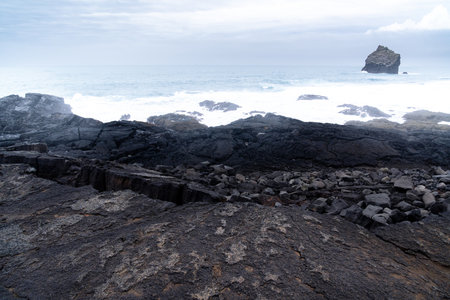 particular rock in the stretch of coast called Valahnukamol in the Reykjanes Peninsula during a cloudy dayの写真素材