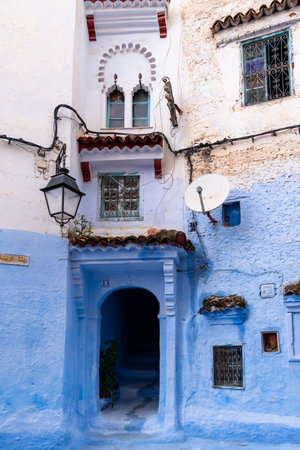 Chefchaouen, Morocco -march 26, 2024:Vertical photo of the entrance of a typical blue house in Chefchaouen, a characteristic town in Morocco, during a cloudy dayのeditorial素材