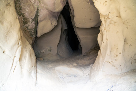 entrance carved by wind and water in the Soprasasso caves in Emilia during a cloudy dayの写真素材