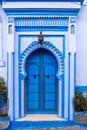 Chefchaouen, Morocco -march 26, 2024:Vertical photo of a beautiful blue door in the famous city of Chefchaouen in Morocco, during a cloudy dayのeditorial素材