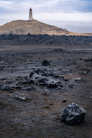 Reykjanes peninsula, Iceland-March 17, 2025:Vertical photograph of Reykjanes Lighthouse seen from the coast in Iceland's Reykjanes Peninsula on a cloudy dayのeditorial素材
