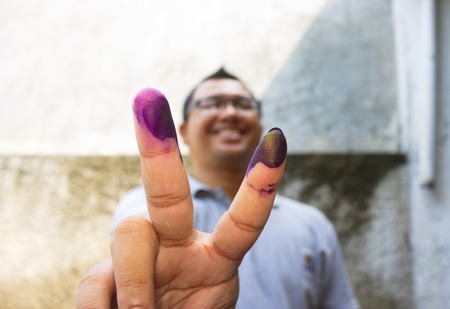 Man show his marked finger after vote