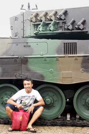 Jakarta, Indonesia - December 13, 2014: Man crouch beside new Leopard tank that bought from Germany by the Indonesian National Armed Forcesのeditorial素材