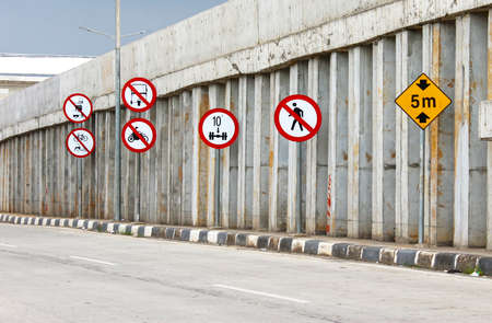 Several traffic signs on the side of the roadの写真素材