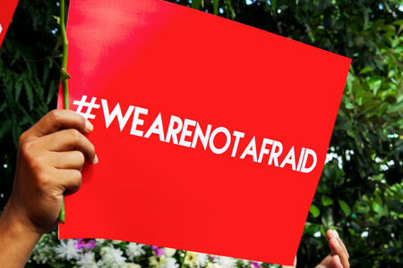 Red leaflet printed with a hashtag letter to invite peoples to not afraid.の写真素材