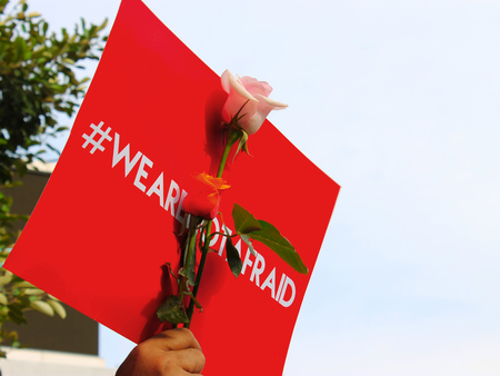 Flower and red leaflet printed with a hashtag letter to invite peoples to not afraid.
