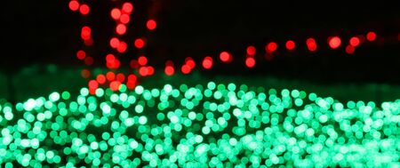 Blur/Defocus shot of red and green colored LED lights on the field.