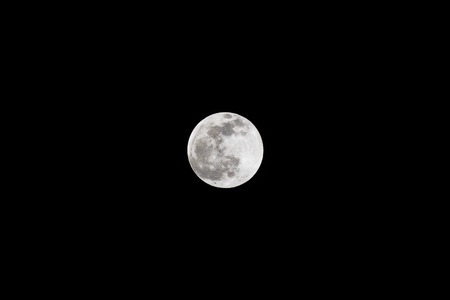 Full moon isolated in the dark sky. The bright and the dark colors shows the moon surface.