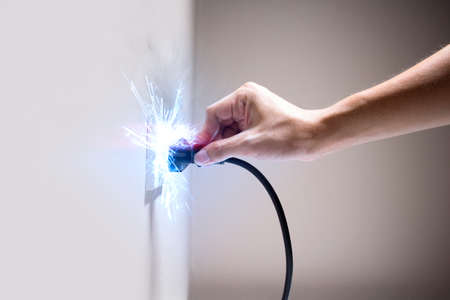 Hand connecting electrical plug cause electric shock, Idea for causes of home fire, Electric short...